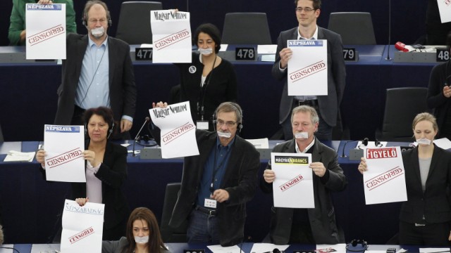 Members of the Greens group of the European Parliament hold posters with word 'Censored' and the names of Hungarian newspapers during the statement of Hungarian Prime Minister Orban at the European Parliament in Strasbourg