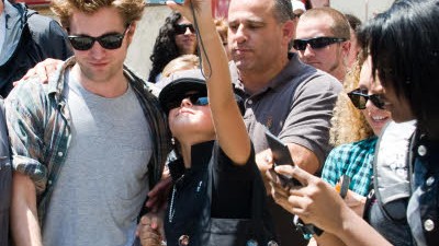 Robert Pattinson flieht vor "Twilight"-Fans: Robert Pattinson (der junge Mann mit Sonnenbrille in der Mitte) wird derzeit auf Schritt und Tritt von begeisterten Fans und besorgten Bodyguards begleitet