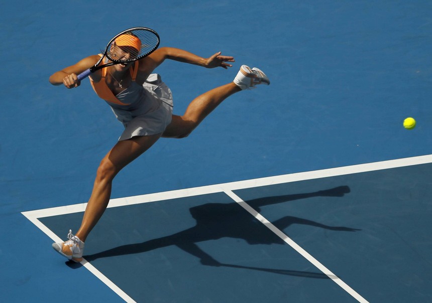 Sharapova of Russia hits a return to Goerges of Germany during their match at the Australian Open tennis tournament in Melbourne
