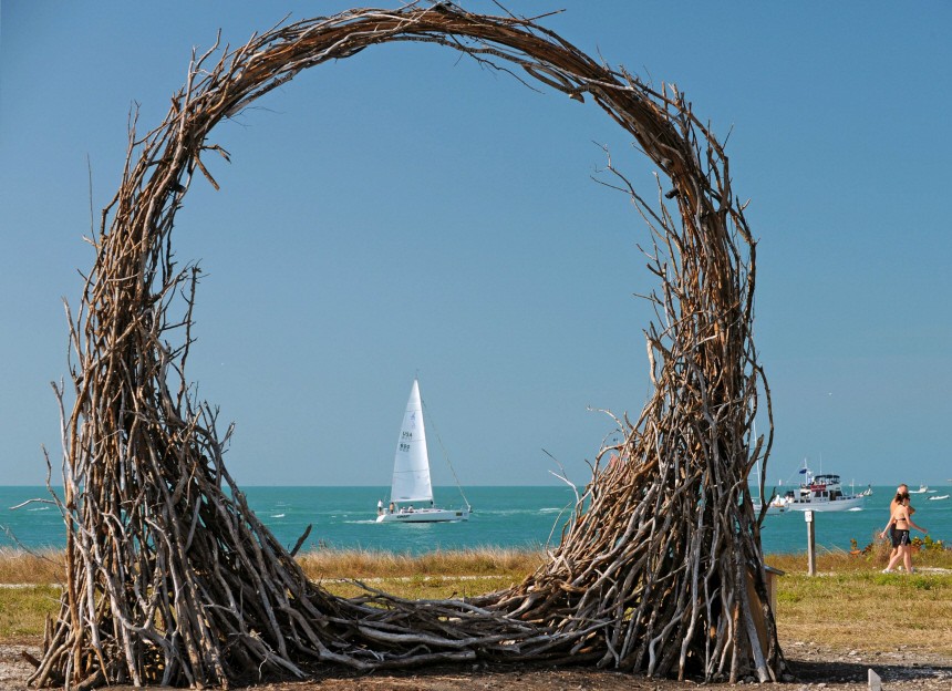 A sailboat is framed by a wood sculpture in Florida