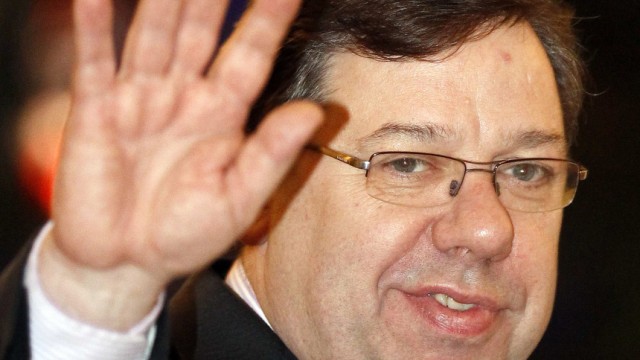 Brian Cowen, Irish Prime Minister and leader of Fianna Fail waves to photographers after winning a vote of confidence from members of his own party in Dublin