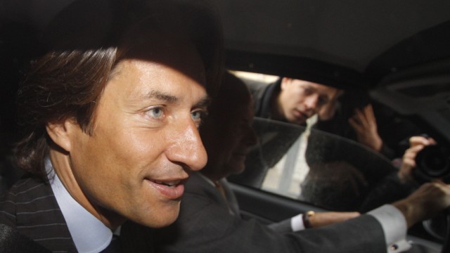 Austrian former Finance Minister Grasser sits in a car as he arrives to be questioned by the Anti-Corruption Authority in Vienna