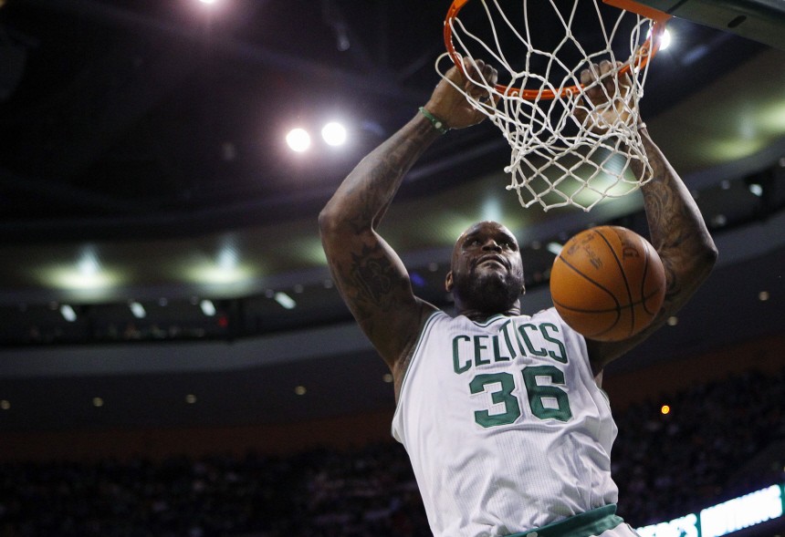 Boston Celtics center Shaquille O'Neal dunks the ball against the Detroit Pistons in the second quarter of their NBA basketball game in Boston