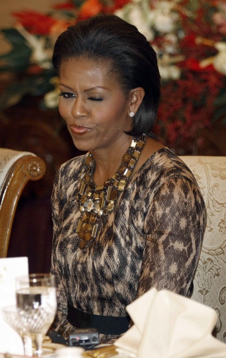 U.S. first lady Michelle Obama winks at another guest at the head table at a state dinner in Jakarta