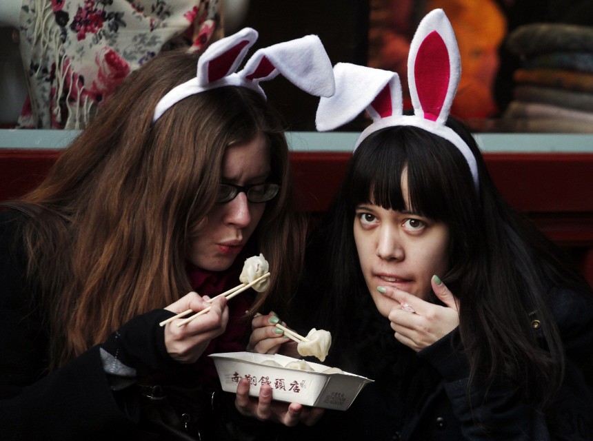 Tourists wearing bunny ears eat dumplings at the Yuyuan Garden in downtown Shanghai