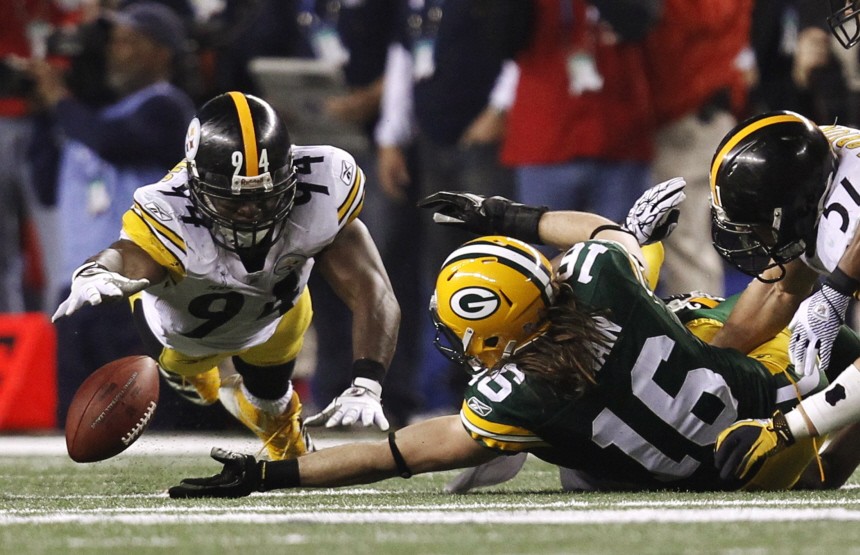 Packers' Swain and Steelers' Timmons reach for the ball after an incomplete pass in the third quarter during the NFL's Super Bowl XLV football game in Arlington