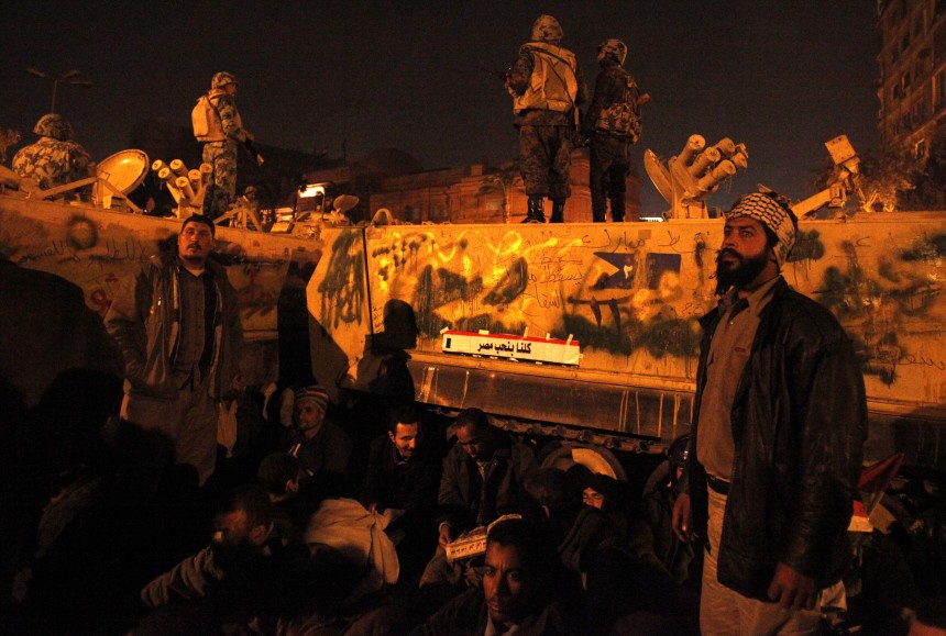 Protesters gather around army vehicles at Tahrir Square in Cairo