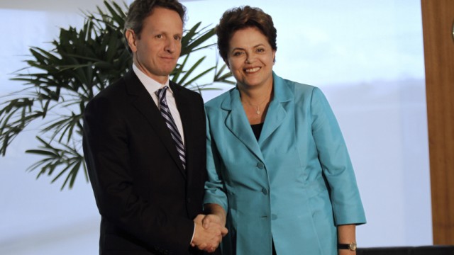 Brazil's President Dilma Rousseff poses with U.S. Treasury Secretary Timothy Geithner during a meeting in Brasilia