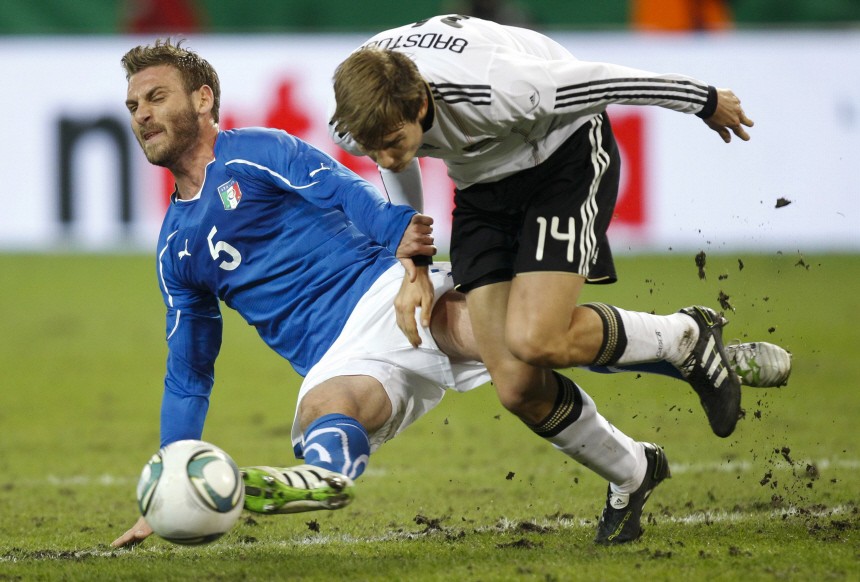 Germany's Badstuber is challenged by Italy's De Rossi during their international friendly soccer match in Dortmund