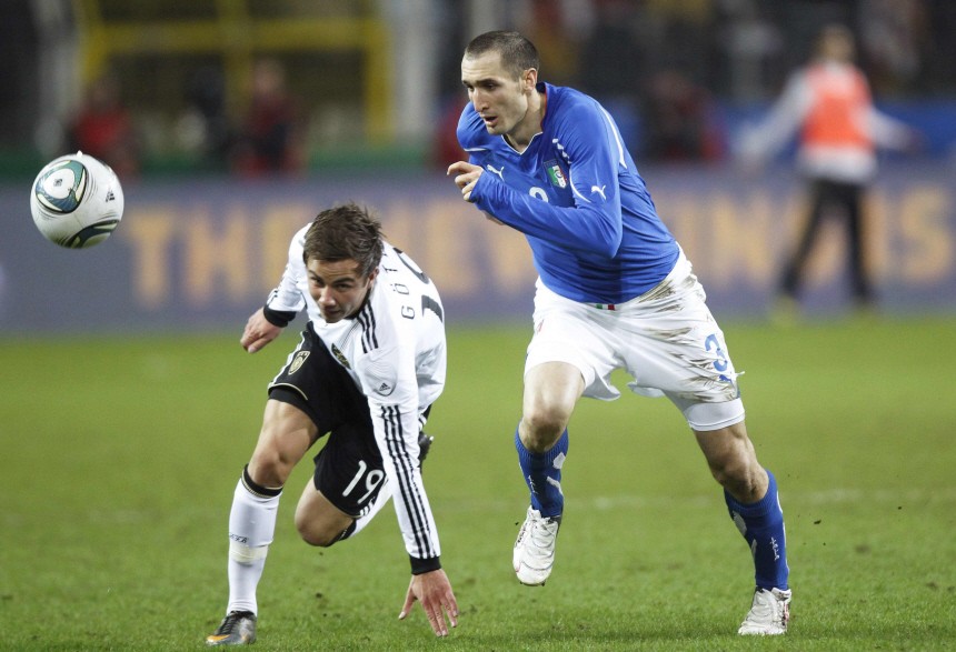 Germany's Goetze is challenged by Italy's Chiellini during their international friendly soccer match in Dortmund