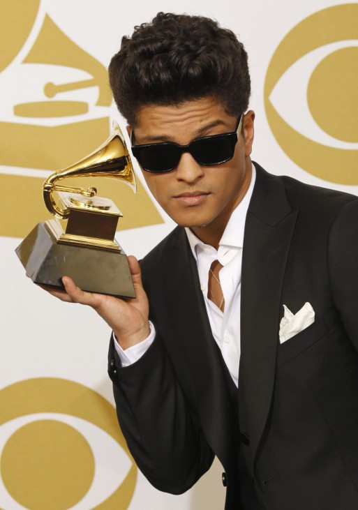 Bruno Mars poses backstage with his award at the 53rd annual Grammy Awards in Los Angeles