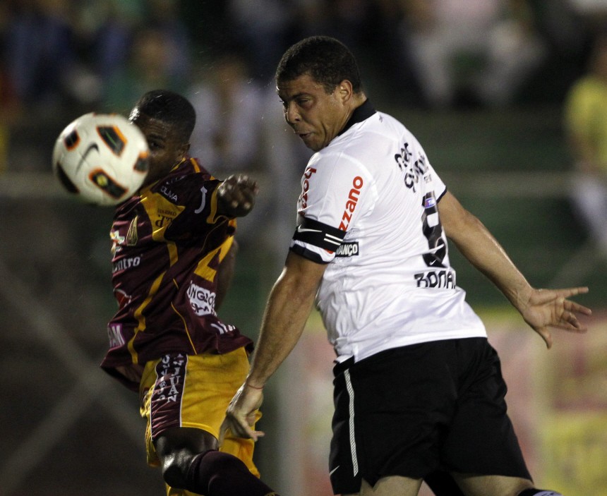 Ronaldo, of Brazil's Corinthians heads for the ball against Hurtado of Colombia's Deportes Tolima during their Copa Libertadores soccer match in Ibague