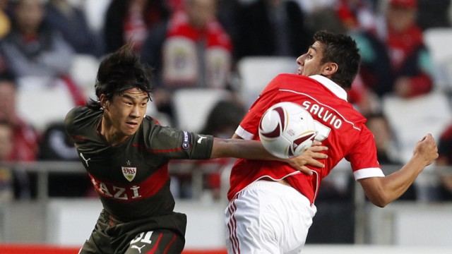 Benfica's Salvio challenges VfB Stuttgart's Okazaki during their Europa League last 32, first leg soccer match at Luz stadium in Lisbon