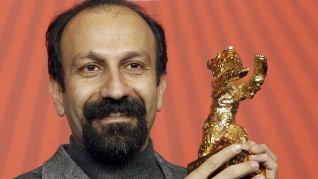 Iranian director Asghar Farhadi poses with Golden Bear award at 61st Berlinale International Film Festival in Berlin