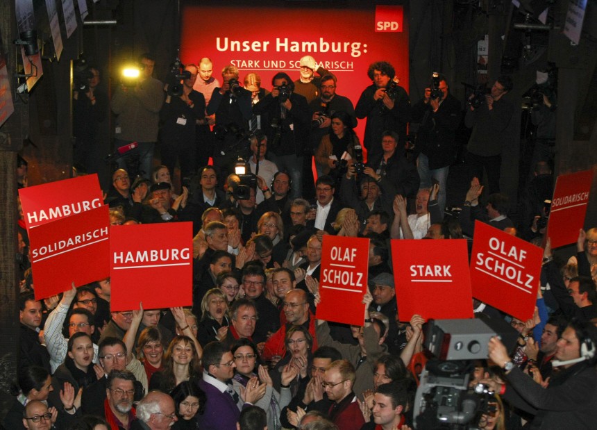 Social Democratic Party (SPD) supporters react at the SPD headquarters in Hamburg