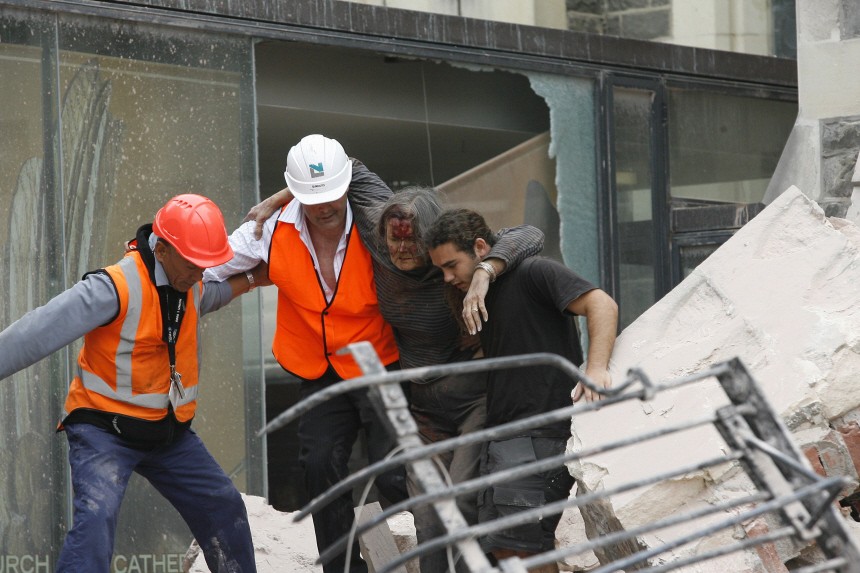 A woman is rescued from inside the Pyne Gould Corporation building after an earthquake in Christchurch