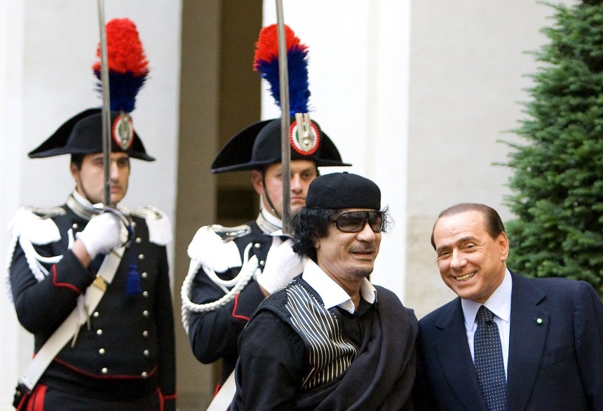 Libya's leader Gaddafi smiles with Italian Prime Minister Berlusconi as he arrives at Chigi palace in Rome