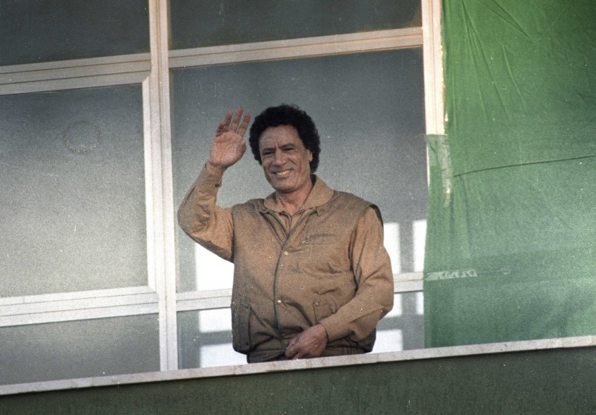 File photo of Libyan leader Muammar Gaddafi waving to supporters as he gives a speech condemning the U.S. from a balcony at Bab al-Aziziya in Tripoli