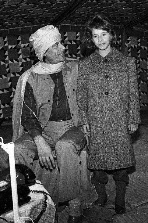 File photo of Libyan leader Muammar Gaddafi smiling at his daughter Aysha during a news conference inside his Bedouin tent erected in the heavily fortified Bab El-Assaria barracks on the outskirts of Tripoli