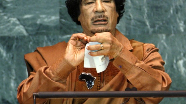 Libyan leader Gaddafi pretends to rip a charter as he addresses the 64th United Nations General Assembly at the U.N. headquarters in New York