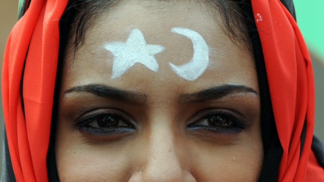 Live-Ticker: Aufstand in Libyen: Eine Libyerin protestiert vor der libyschen Botschaft in Kuala Lumpur gegen das Regime von Staatschef Muammar al-Gaddafi. Auf Kopf und Sirn trägt sie die Symbole und die Flagge des alten Königreichs Libyen, die zum Emblem der Anti-Gaddafi-Proteste geworden sind.