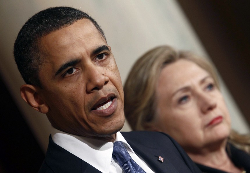 U.S. President Barack Obama speaks about Libya while U.S. Secretary of State Hillary Clinton listens in the White House in Washington