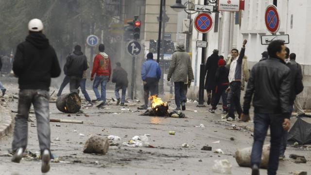Anti-government protesters clash with riot police in downtown in Tunis