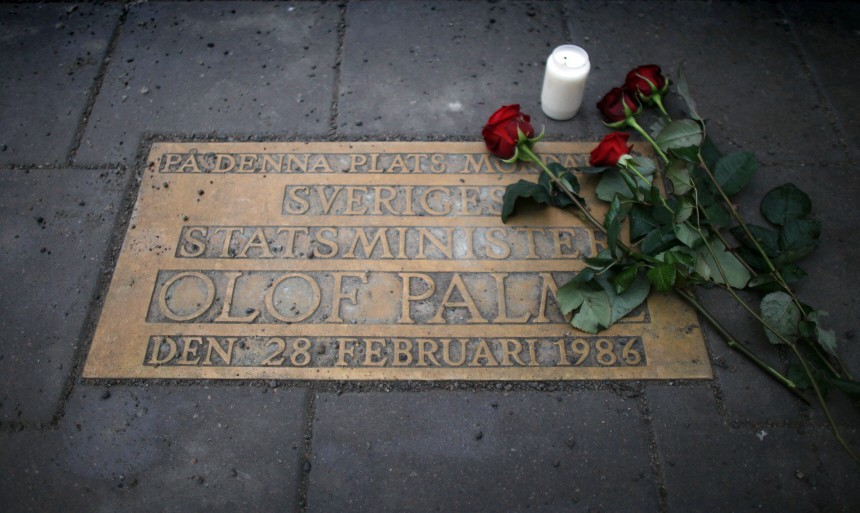 Roses are laid on a plaque marking the location where Swedish Prime Minister Olof Palme was killed 25 years ago in Stockholm