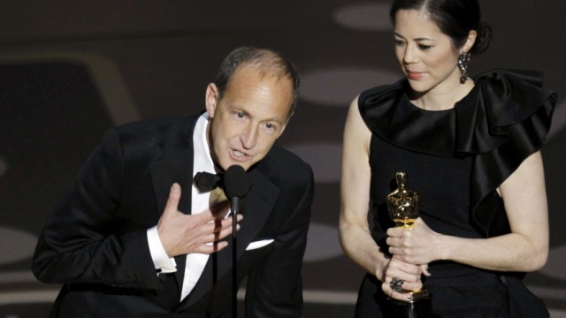 Charles Ferguson and Audrey Marrs accept the Oscar for best documentary feature during the 83rd Academy Awards in Hollywood