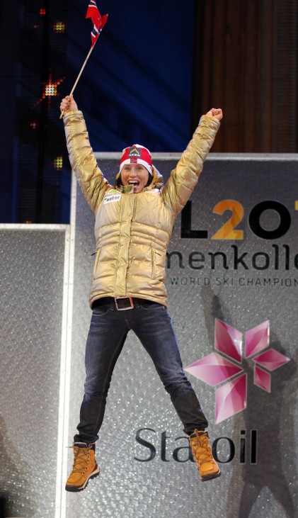 Bjoergen of Norway celebrates during the award ceremony of the women's 10 km cross country individual classic event at the Nordic World Ski Championships in Oslo