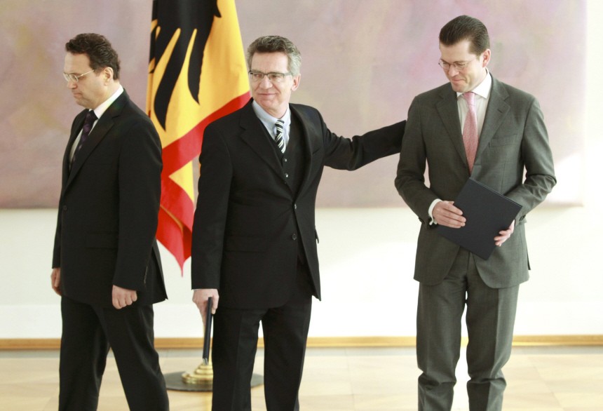 Newly appointed German Interior Minister Friedrich, new Defence Minister de Maiziere and former defence minister zu Guttenberg attend a ceremony in presidential residence Bellevue palace in Berlin