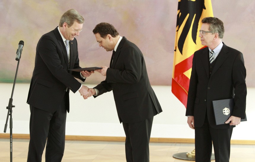 Newly appointed German Interior Minister Friedrich receives credentials from President Wulff as new Defence Minister de Maiziere watches during a ceremony in presidential residence Bellevue palace in Berlin