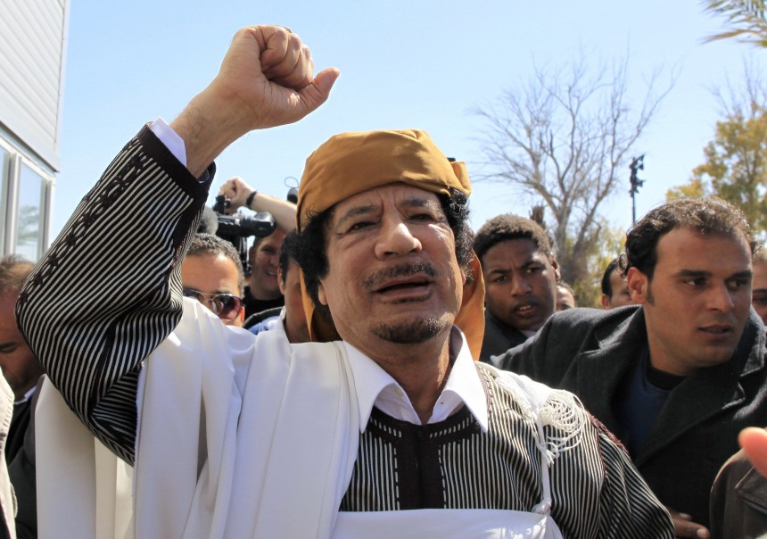 Libyan leader Muammar Gaddafi waves in Tripoli before making a speech