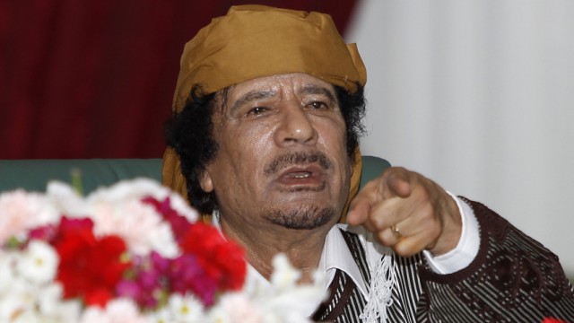 Libya's leader Muammar Gaddafi gestures to his supporters in Tripoli
