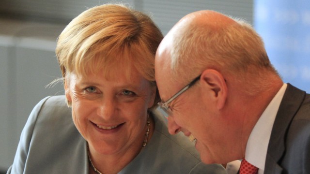 German Chancellor and CDU head Merkel talks with head of CDU parliamentary faction Kauder attend meeting of CDU/CSU parliamentary group in Berlin