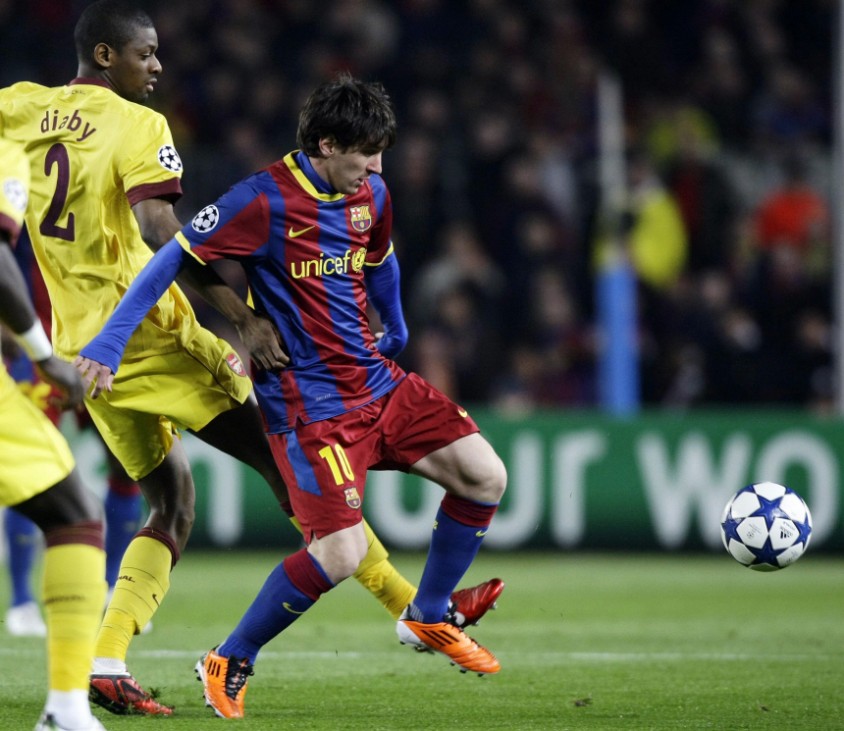 Barcelona's Messi is challenged by Arsenal's Diaby during their Champions League soccer match in Barcelona