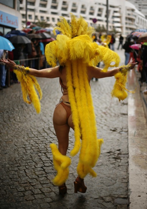 A reveller participates in a samba parade during the carnival in Sesimbra village