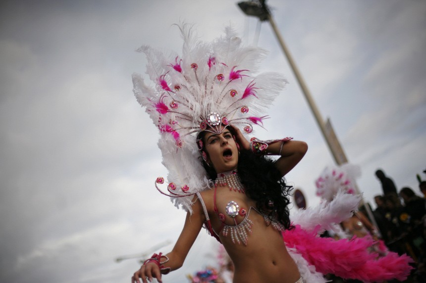 A reveller participates in a samba parade during a carnival in Sesimbra village