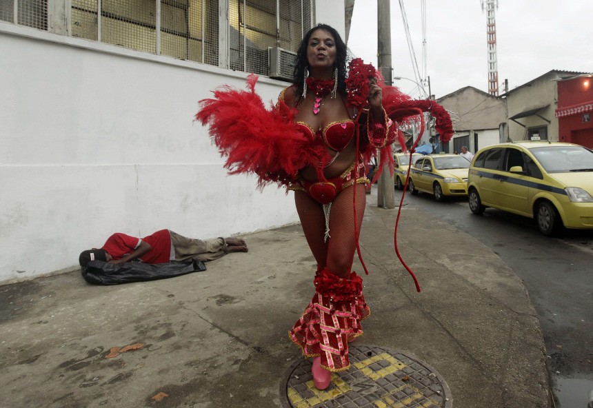 A reveller makes her way home after the second night of the annual Carnival parade in Rio