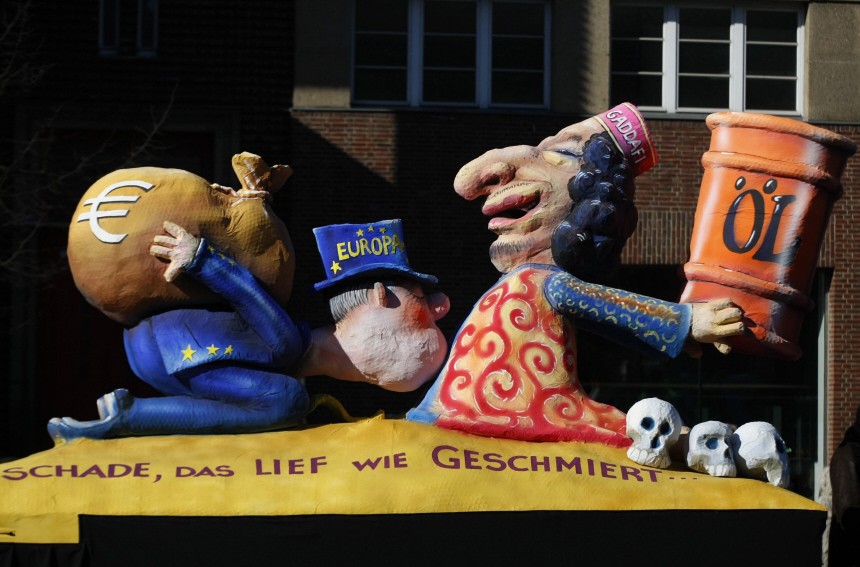 A carnival float representing Libya's leader Gaddafi  carrying an oil barrel facing a european man with a bag of money is pictured in Duesseldorf