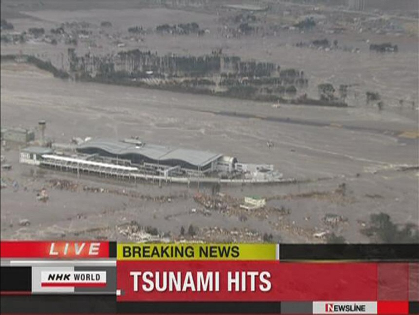 Sendai airport is flooded in this still image taken from video