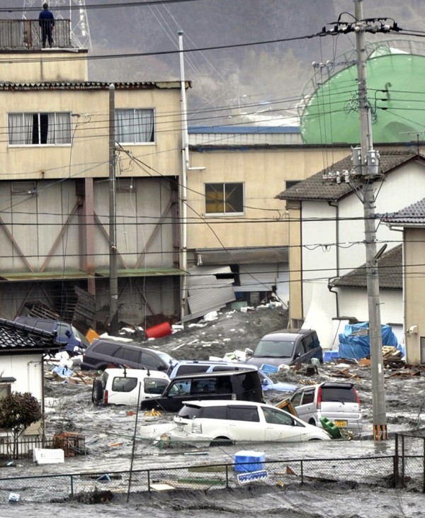 Streets are flooded after a tsunami and earthquake in Kesennuma city