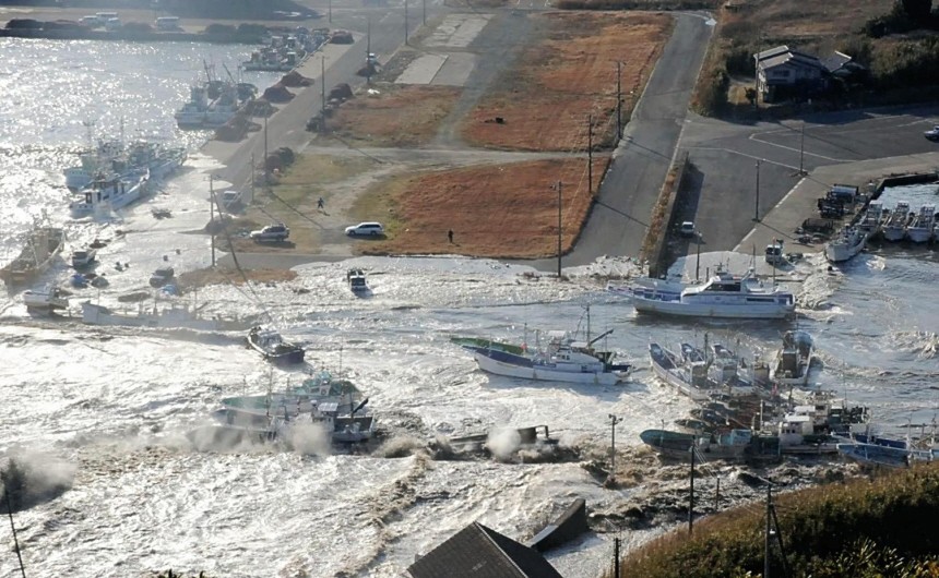 Boats are swept by a wave after a tsunami and earthquake in Asahikawa city