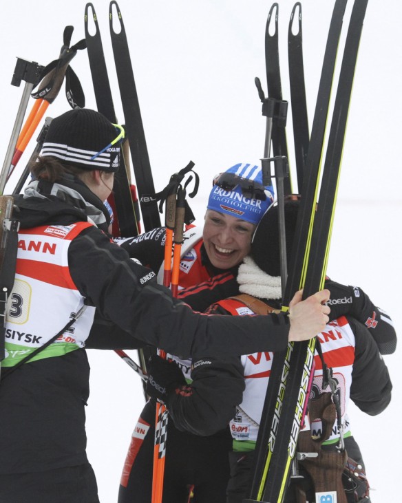 Neuner of Germany celebrates with teammates after crossing the finish line of  the women's 4 x 6 km relay race at the IBU Biathlon World Championships in Khanty-Mansiysk