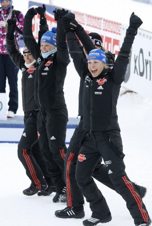Henkel, Gossner, Bachmann, and Neuner of the German women's 4 x 6 km relay race team celebrate gold at the IBU Biathlon World Championships in Khanty-Mansiysk