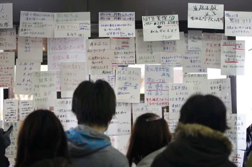 Residents search for the names of their missing family members and relatives in Sendai