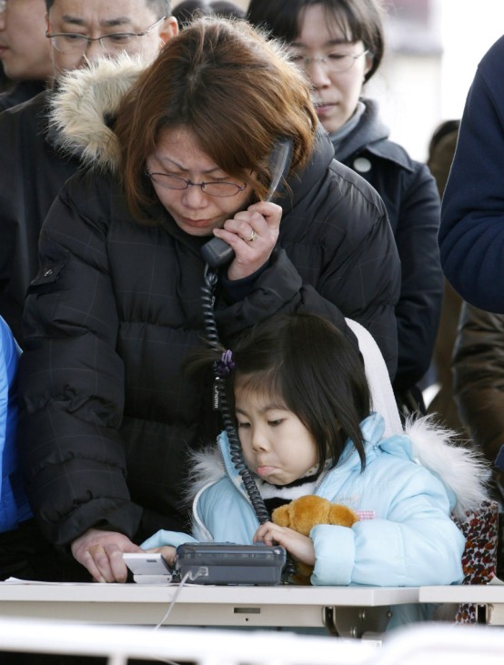 A resident talks on a temporarily-installed public phone in Sendai