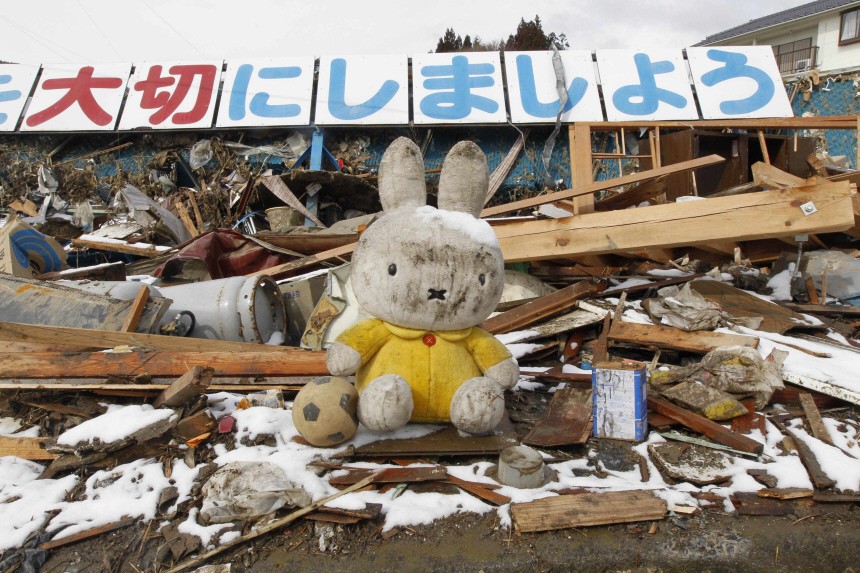A stuffed toy is seen amidst rubble at an area hit by earthquake and tsunami in Kesennuma