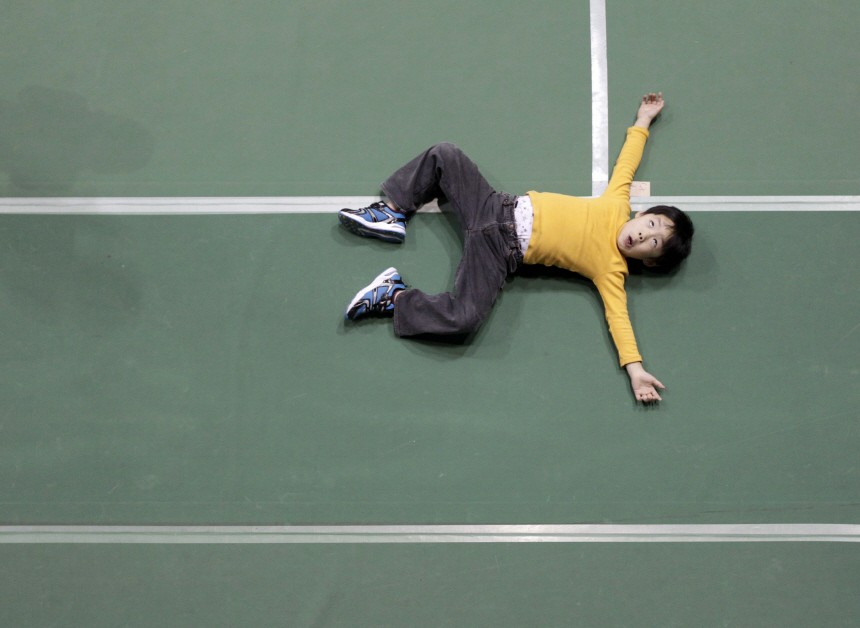 A boy jokes around at an evacuation center set in a gymnasium in Yamagata, northern Japan
