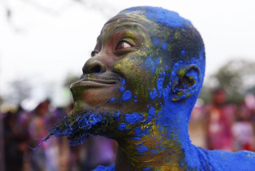 A man smeared with coloured powdered called abeer makes a funny face during Phagwa celebrations in Arranguez